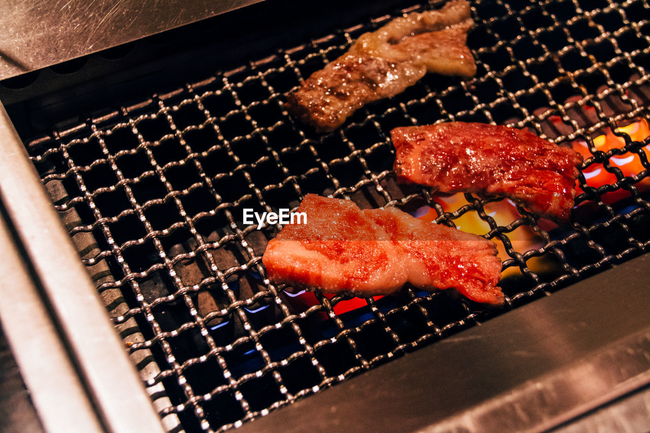 Close-up of meat cooking in barbecue grill