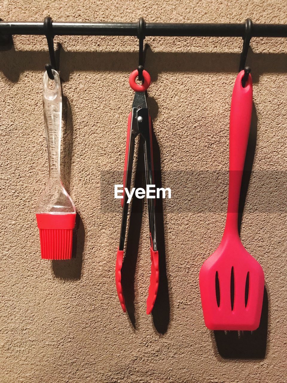 Kitchen utensils hanging against wall