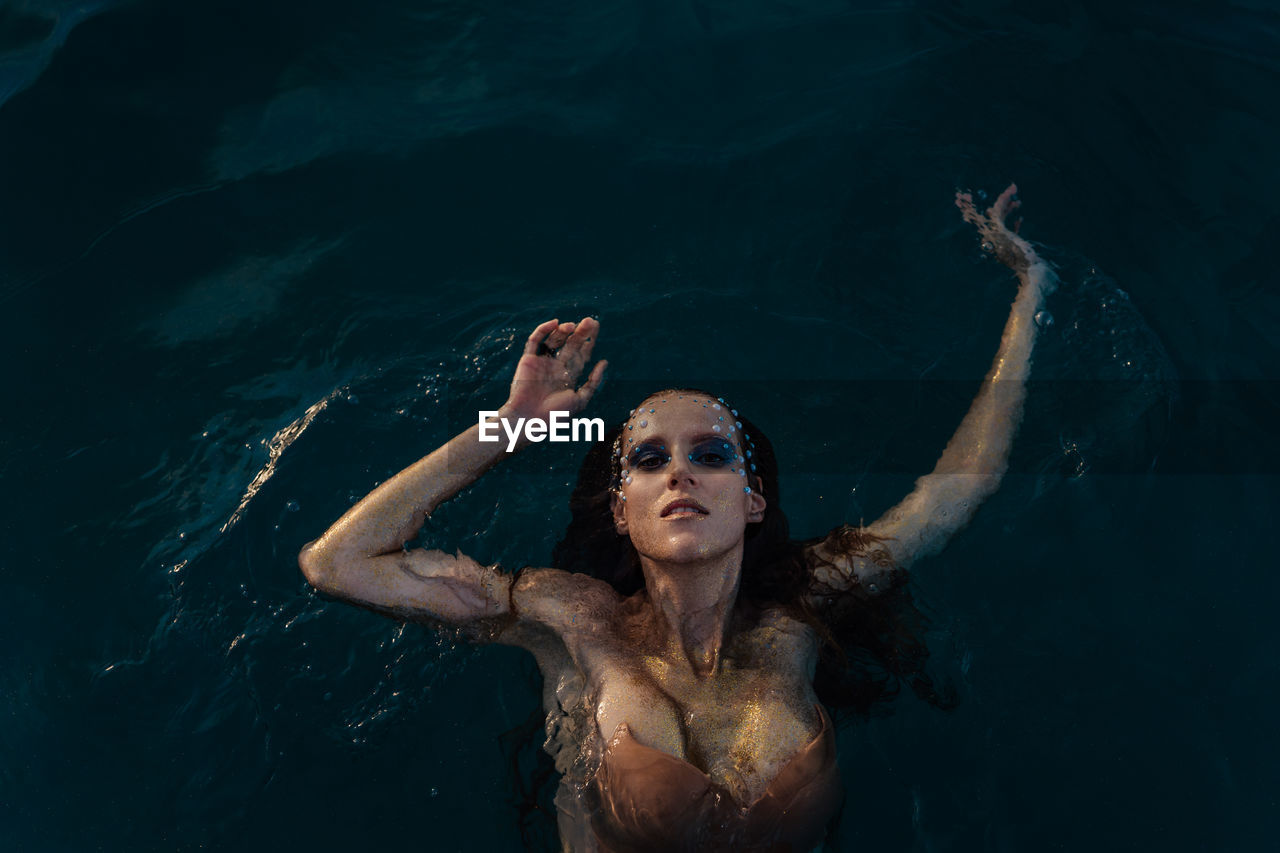 Portrait of woman swimming in sea