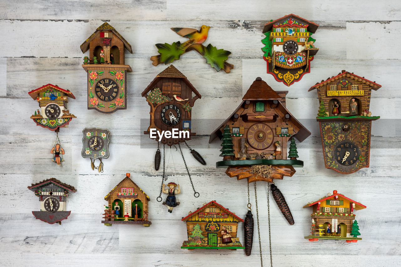 MULTI COLORED CHRISTMAS DECORATIONS ON WOODEN WALL