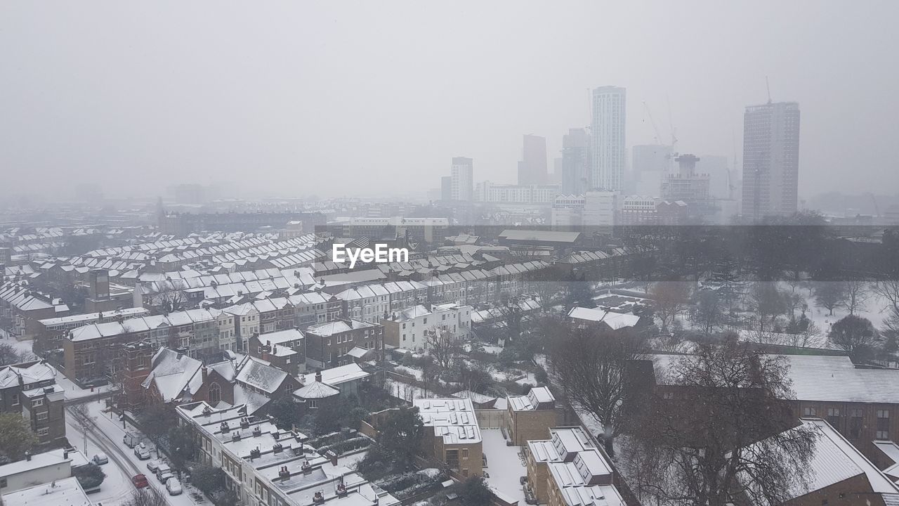 AERIAL VIEW OF CITYSCAPE AGAINST SKY DURING WINTER