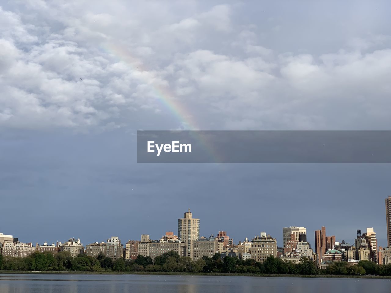 SCENIC VIEW OF RAINBOW OVER CITY BUILDINGS