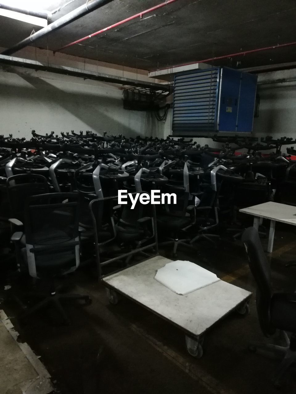VIEW OF EMPTY CHAIRS AND TABLES IN ABANDONED ROOM