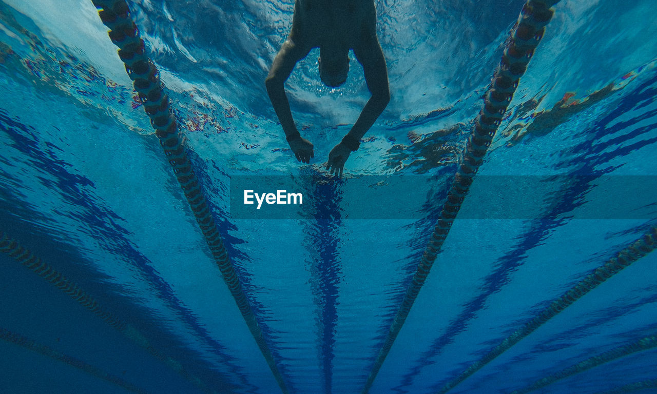 Low angle view of man swimming in pool