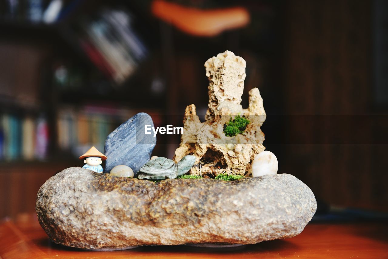 Figurines with stone decor on table