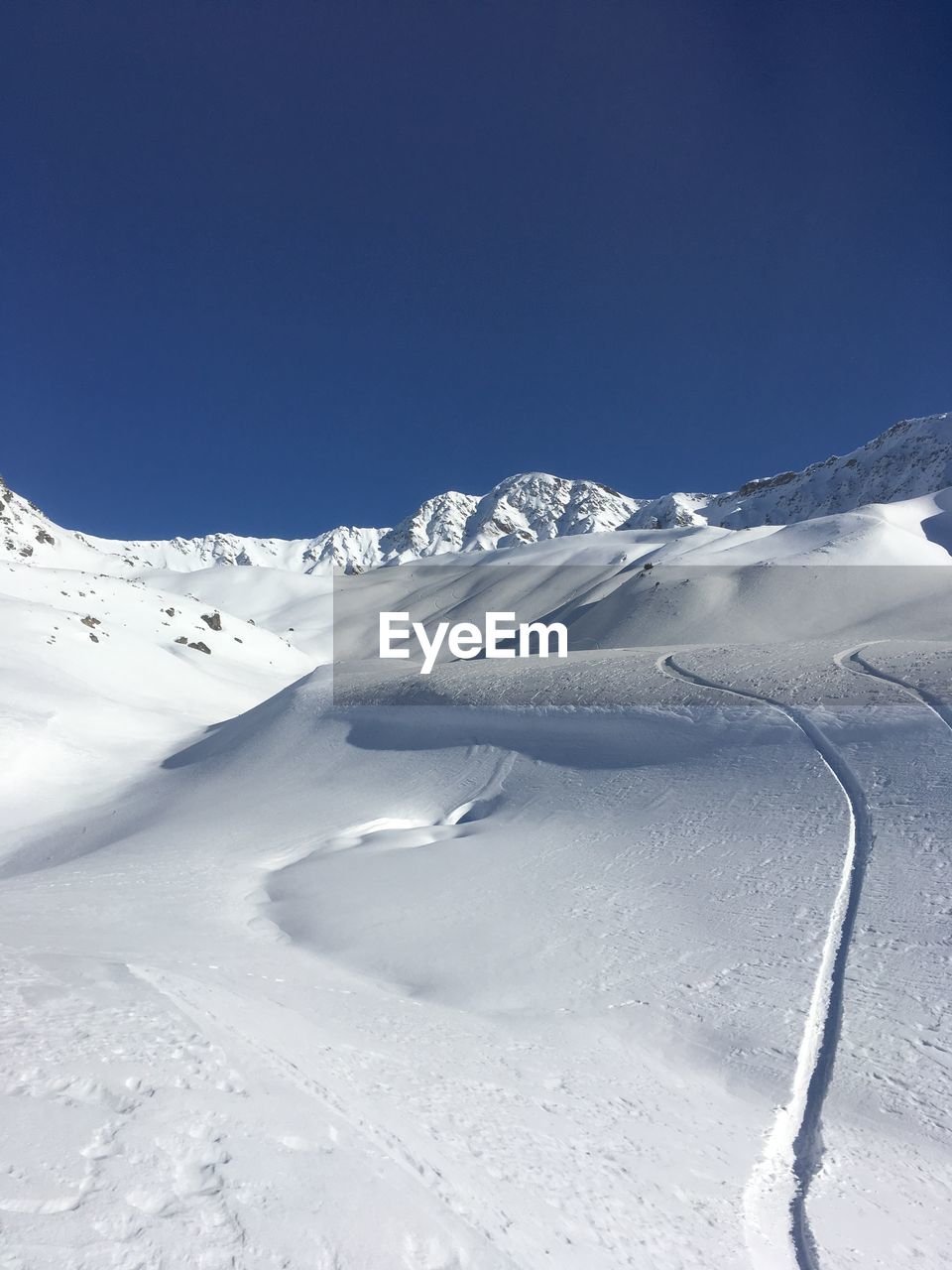 SNOWCAPPED MOUNTAIN AGAINST CLEAR BLUE SKY