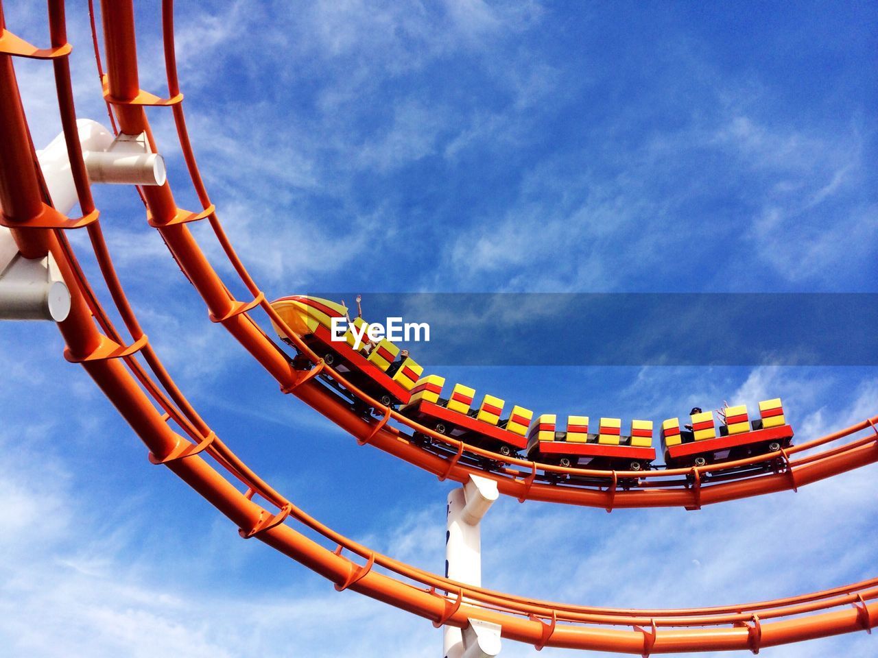 Low angle view of rollercoasters against sky