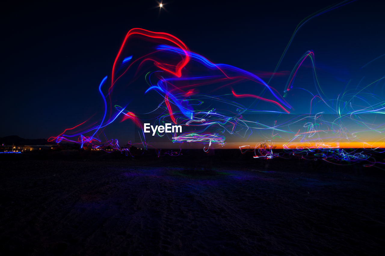 Light trails against sky at night