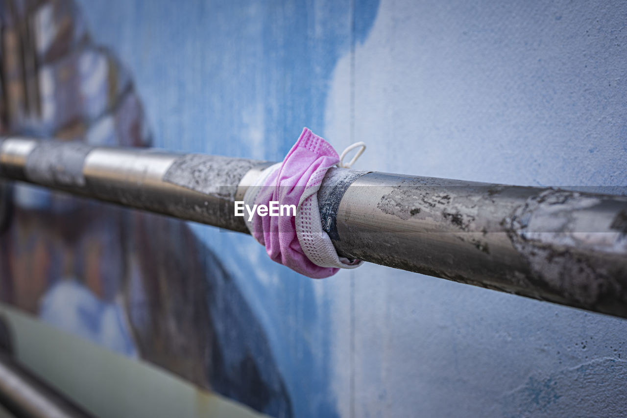 Close-up of mask tied over pipe