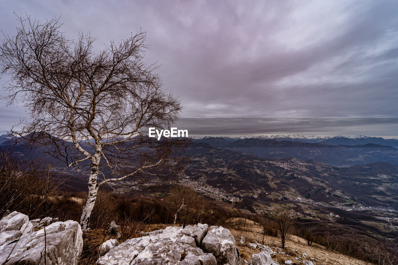 Scenic view of mountains against cloudy sky