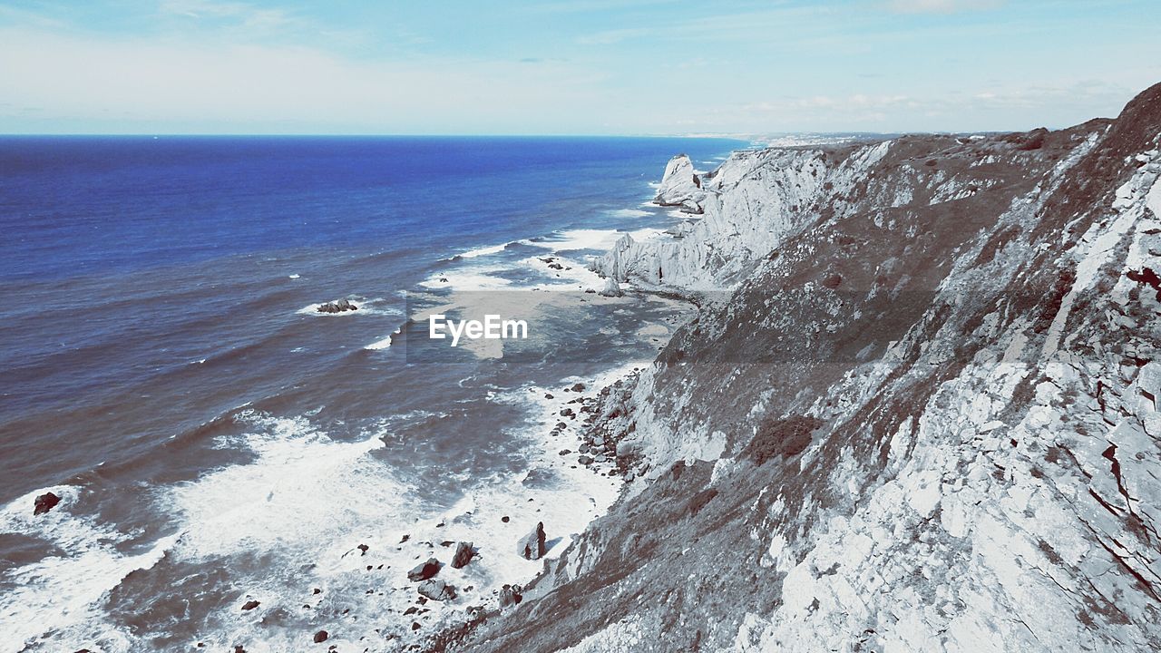 Scenic view of sea against cloudy sky