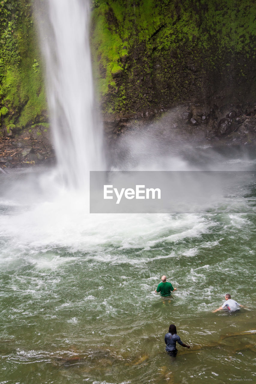 SCENIC VIEW OF WATERFALL AGAINST TREES