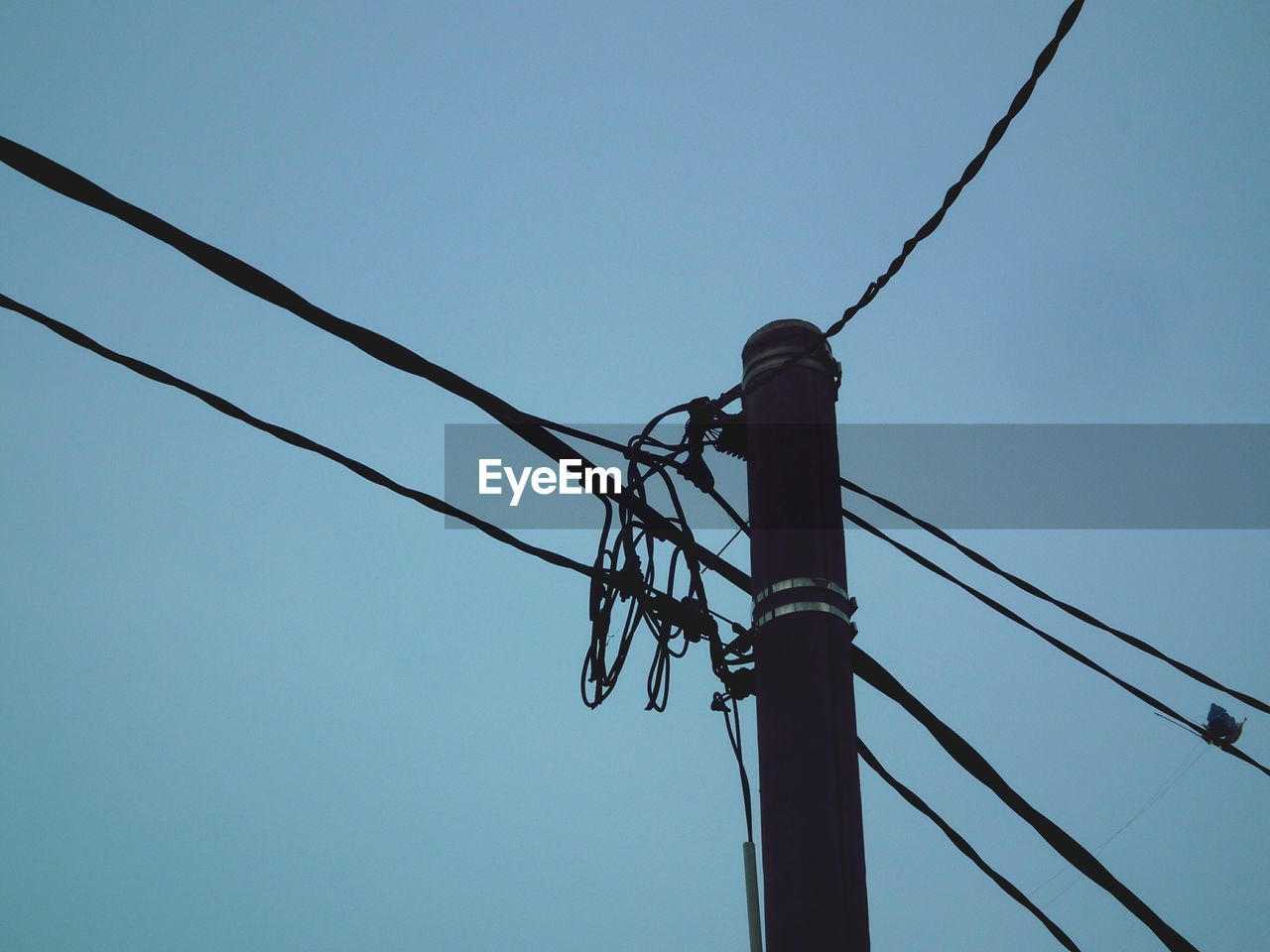 Low angle view of electricity pylon against sky