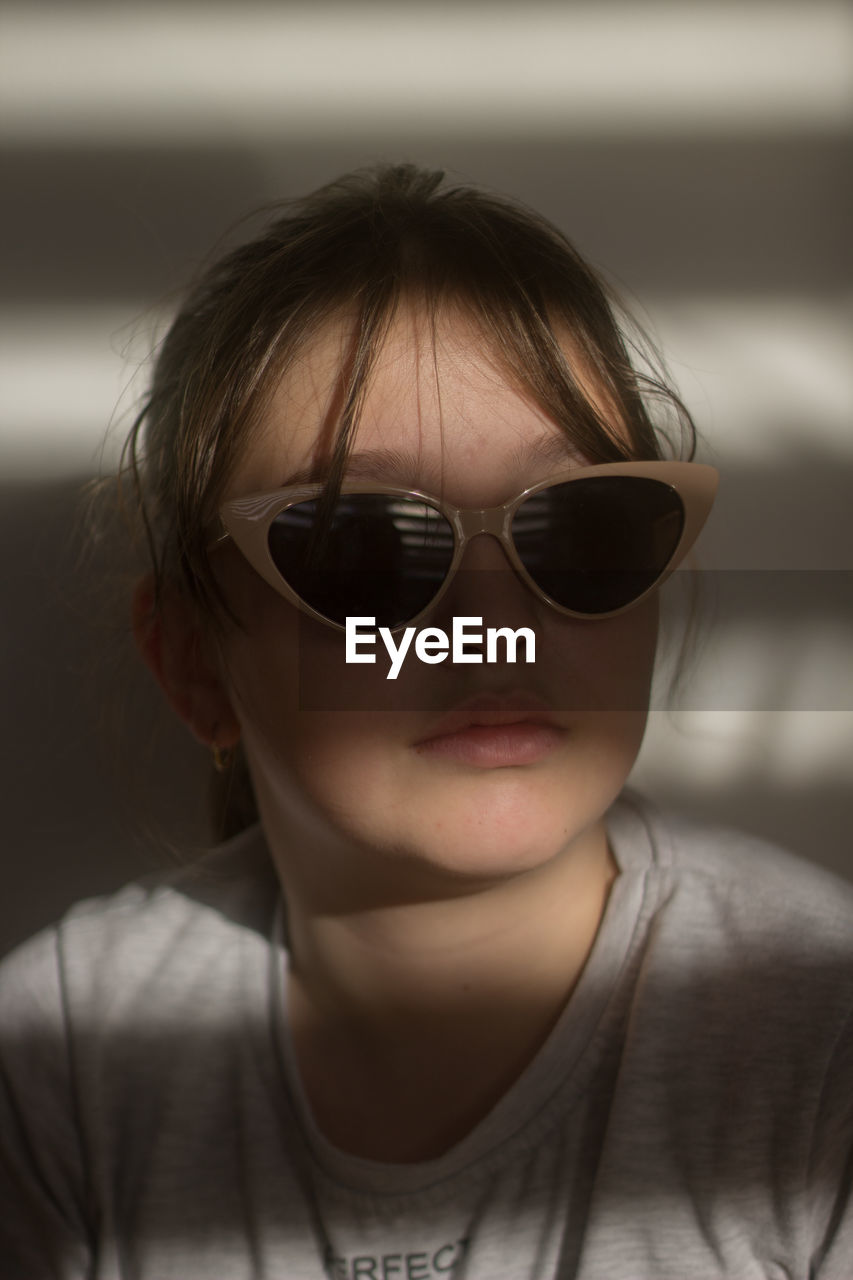 Portrait of young woman wearing sunglasses