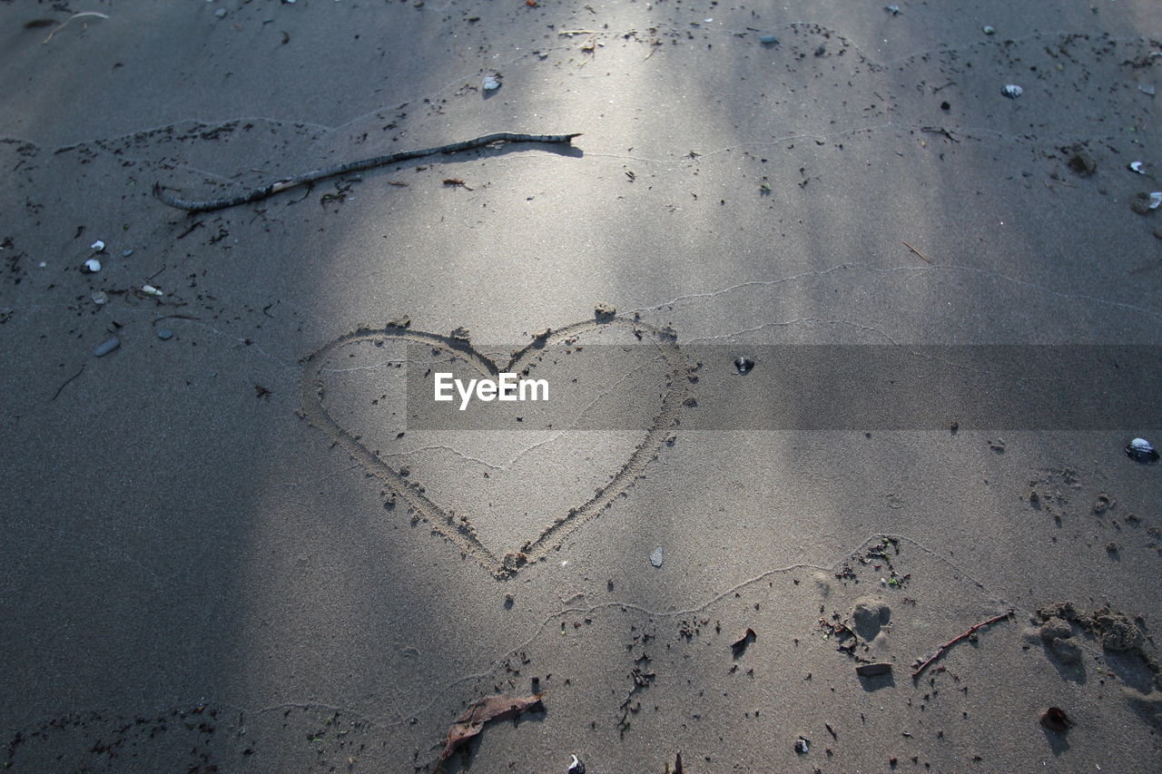 High angle view of heart shape on sand