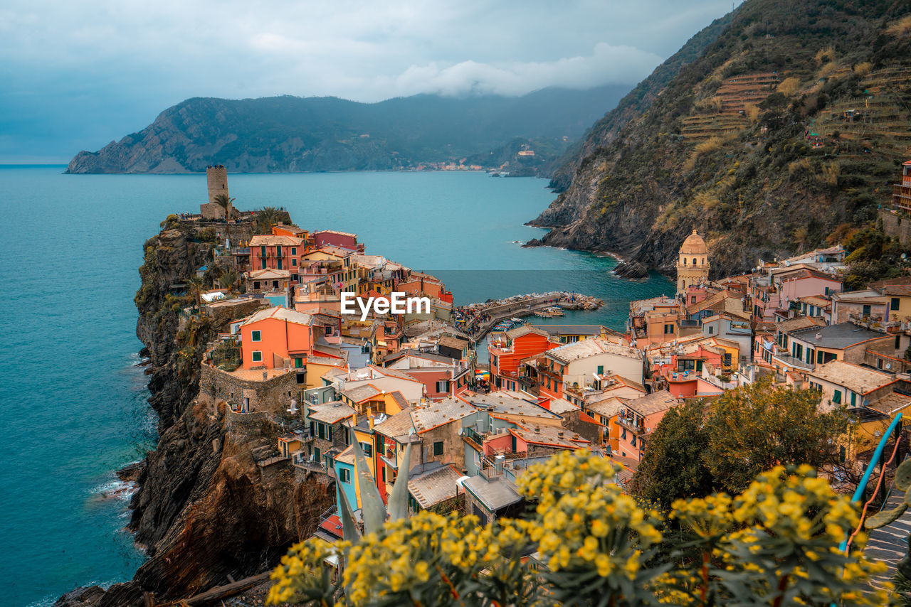 aerial view of townscape by sea against sky