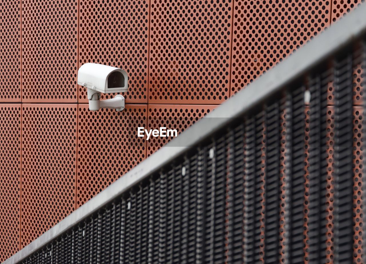 Close-up of security camera on metallic building
