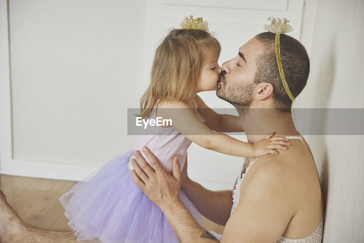 Father and daughter play dressed up as princesses