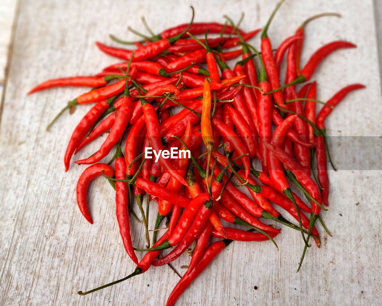 Close-up of red chili peppers on table