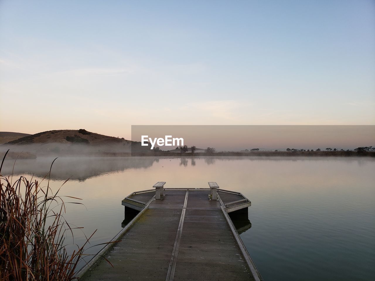 Scenic view of lake against sky during sunset