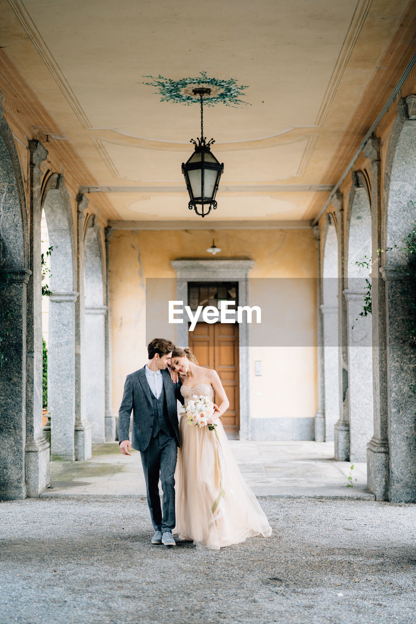 Full length of couple walking in building