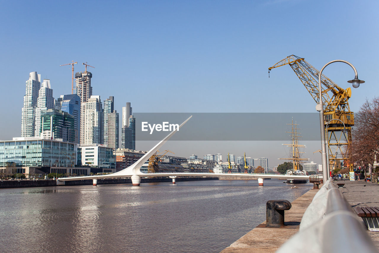 RIVER BY BUILDINGS AGAINST CLEAR SKY