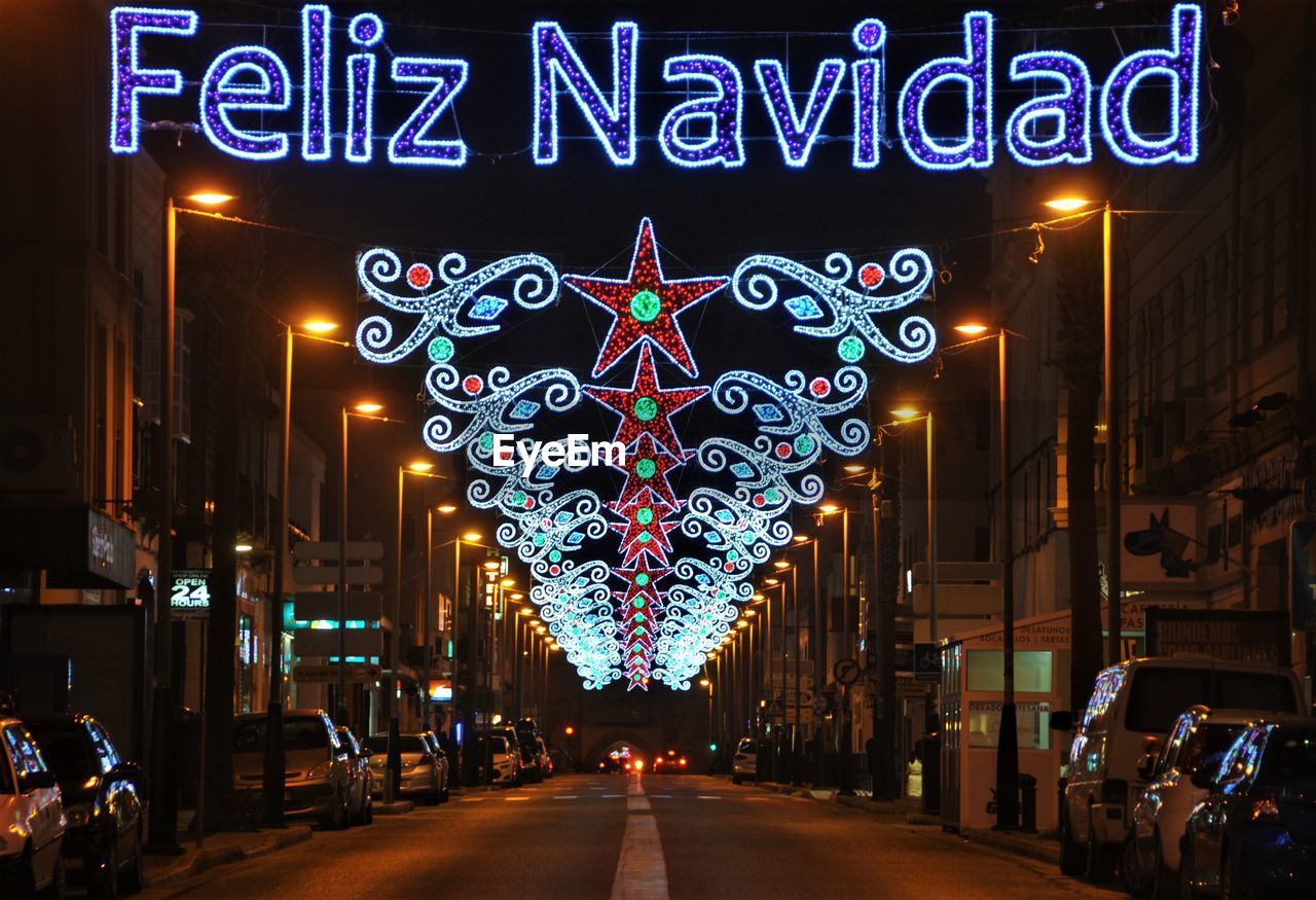 ILLUMINATED STREET LIGHTS IN CITY AT NIGHT