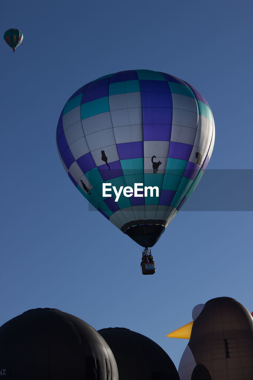 Low angle view of hot air balloon against clear blue sky