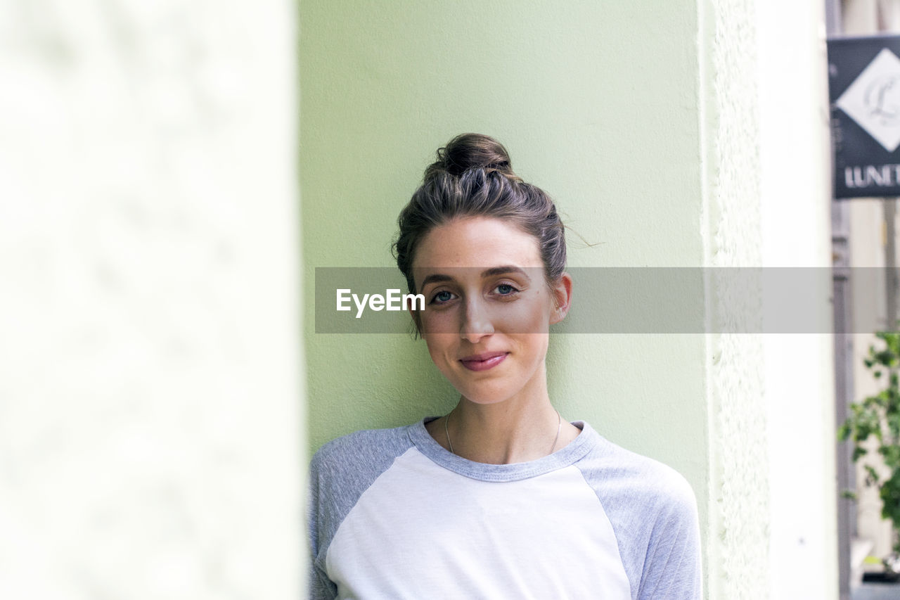 Portrait of smiling young woman with hairbun