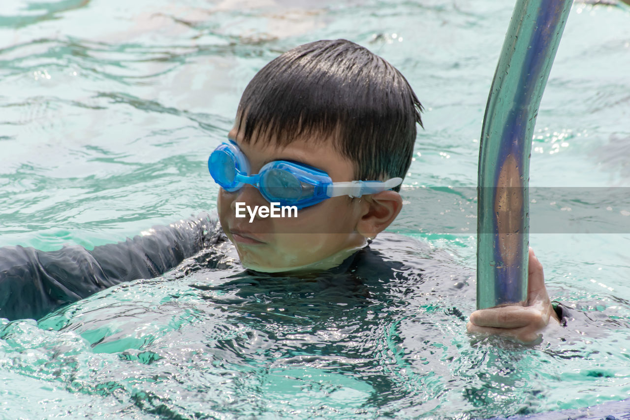 Boy swimming in pool