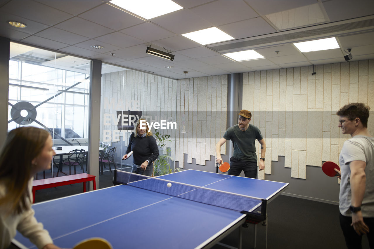 People playing table tennis in office