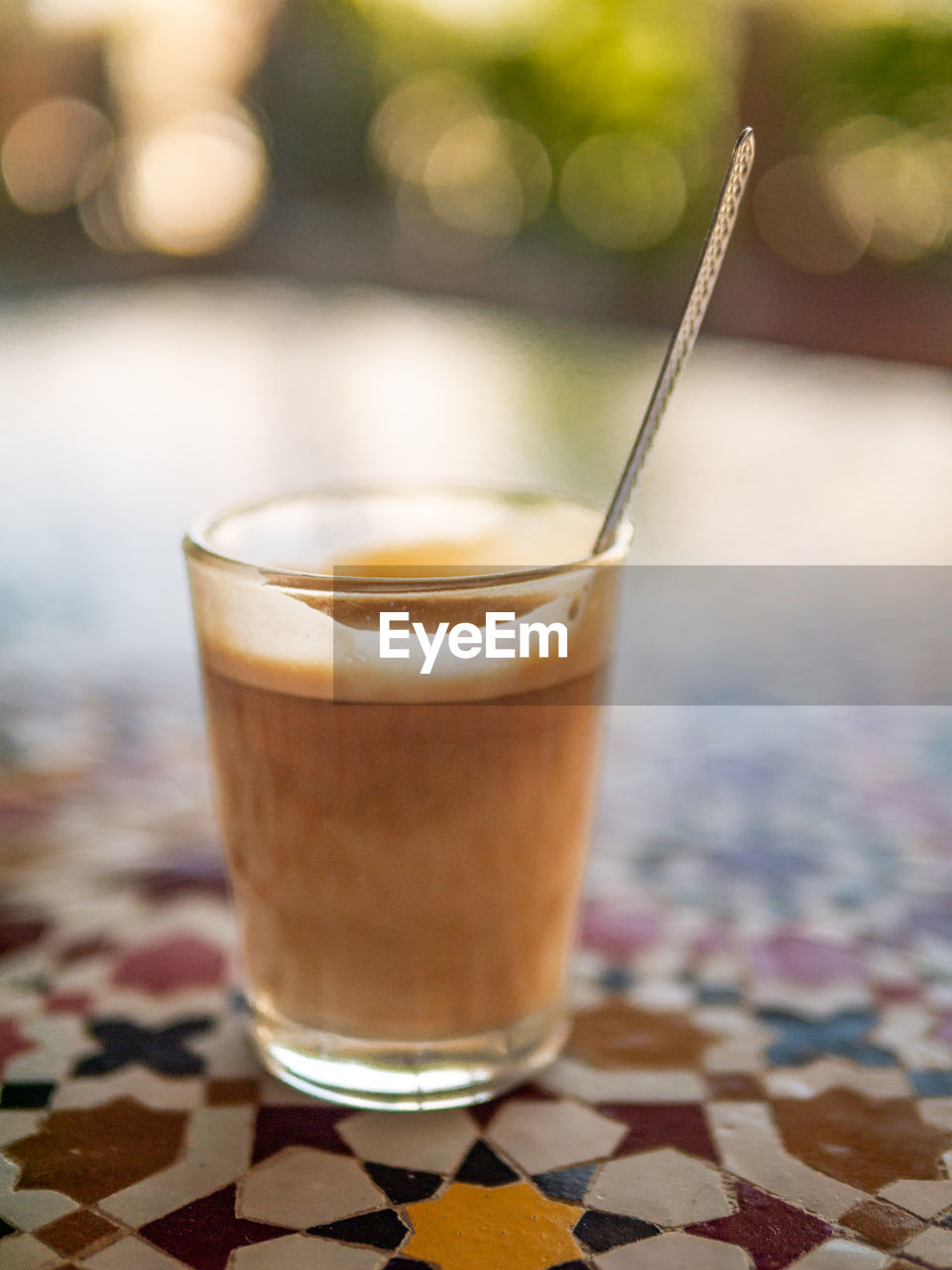 food and drink, drink, refreshment, glass, drinking glass, household equipment, food, coffee, no people, focus on foreground, latte, drinking straw, milkshake, alcoholic beverage, table, straw, close-up, spoon, frappé coffee, hot drink, iced coffee, freshness