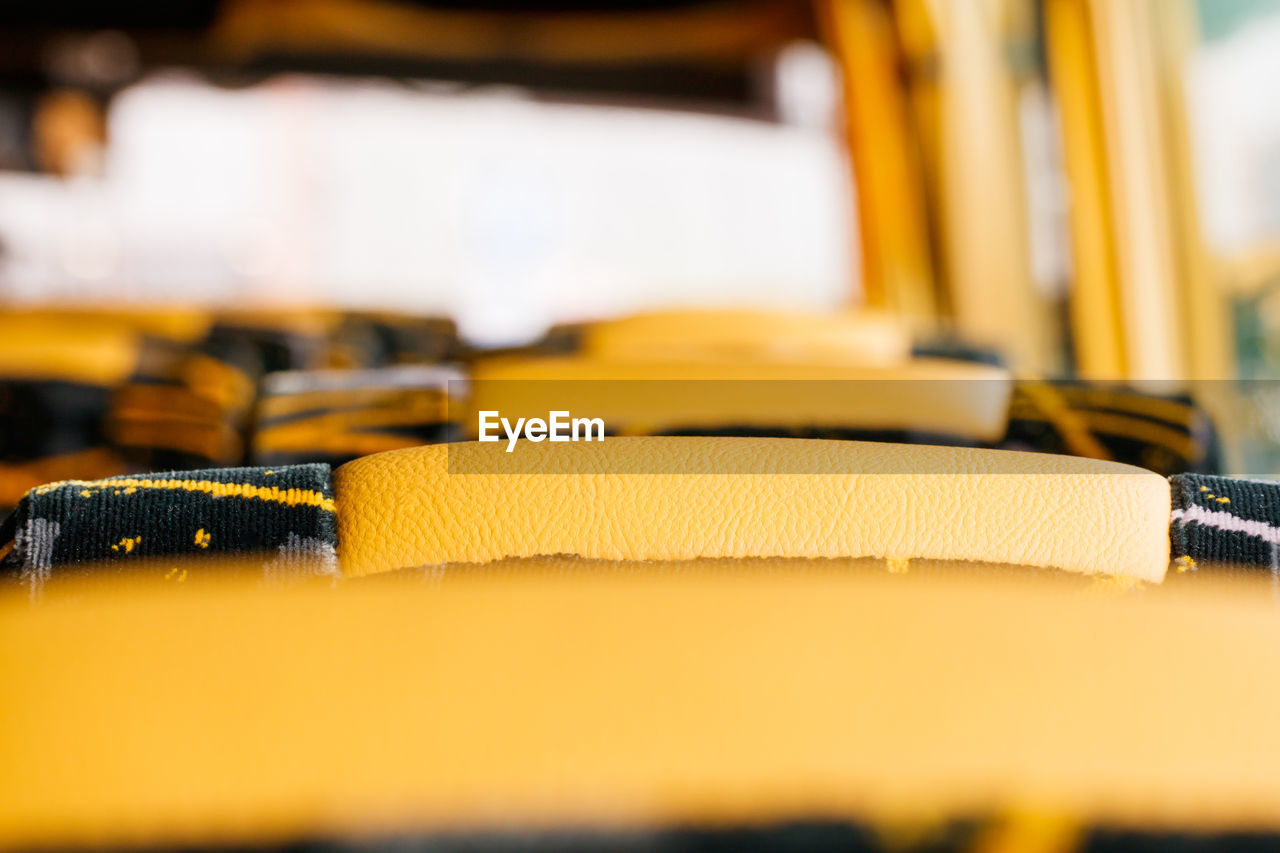 Close-up of yellow vehicle seats in bus