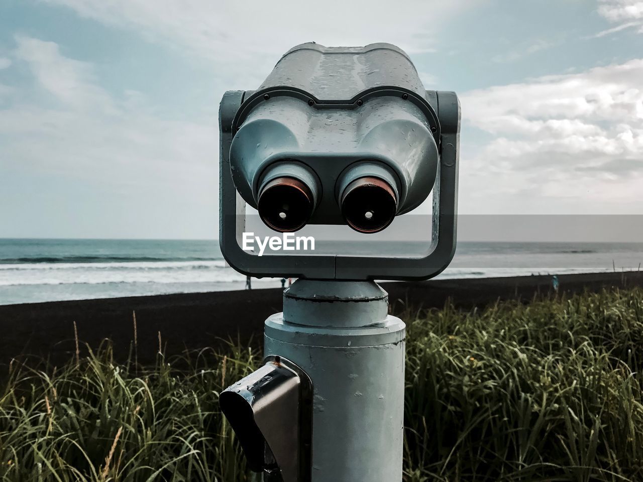 COIN-OPERATED BINOCULARS AGAINST SKY