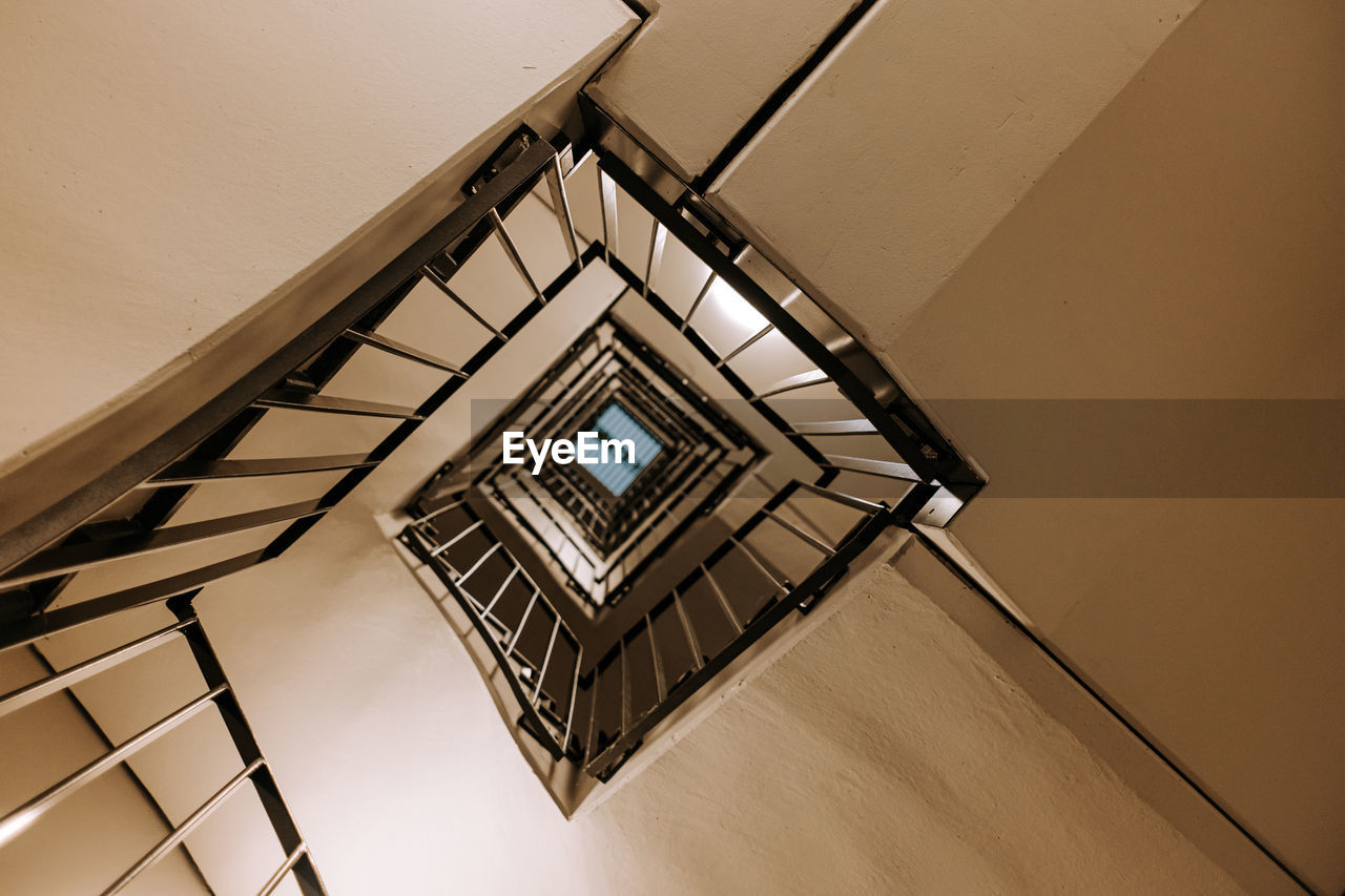 LOW ANGLE VIEW OF SPIRAL STAIRCASE IN BUILDING