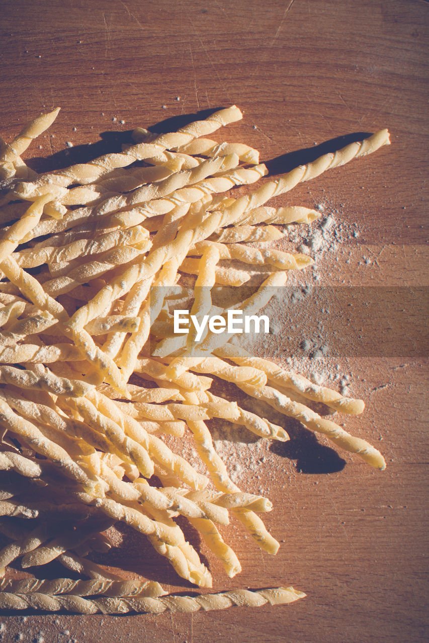 Homemade pasta lying on a wood cutting board