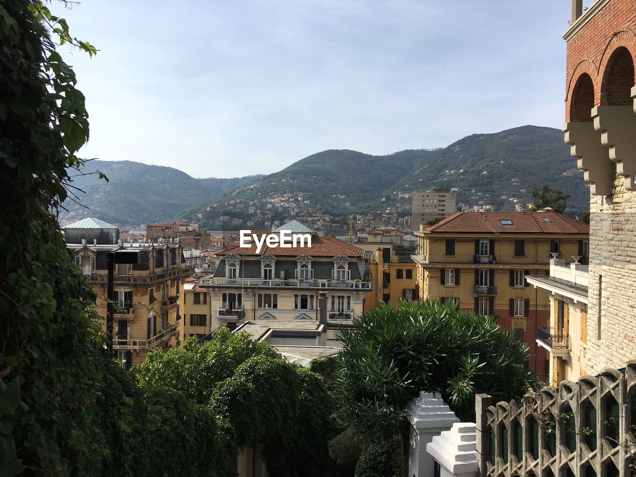 Buildings in town against sky