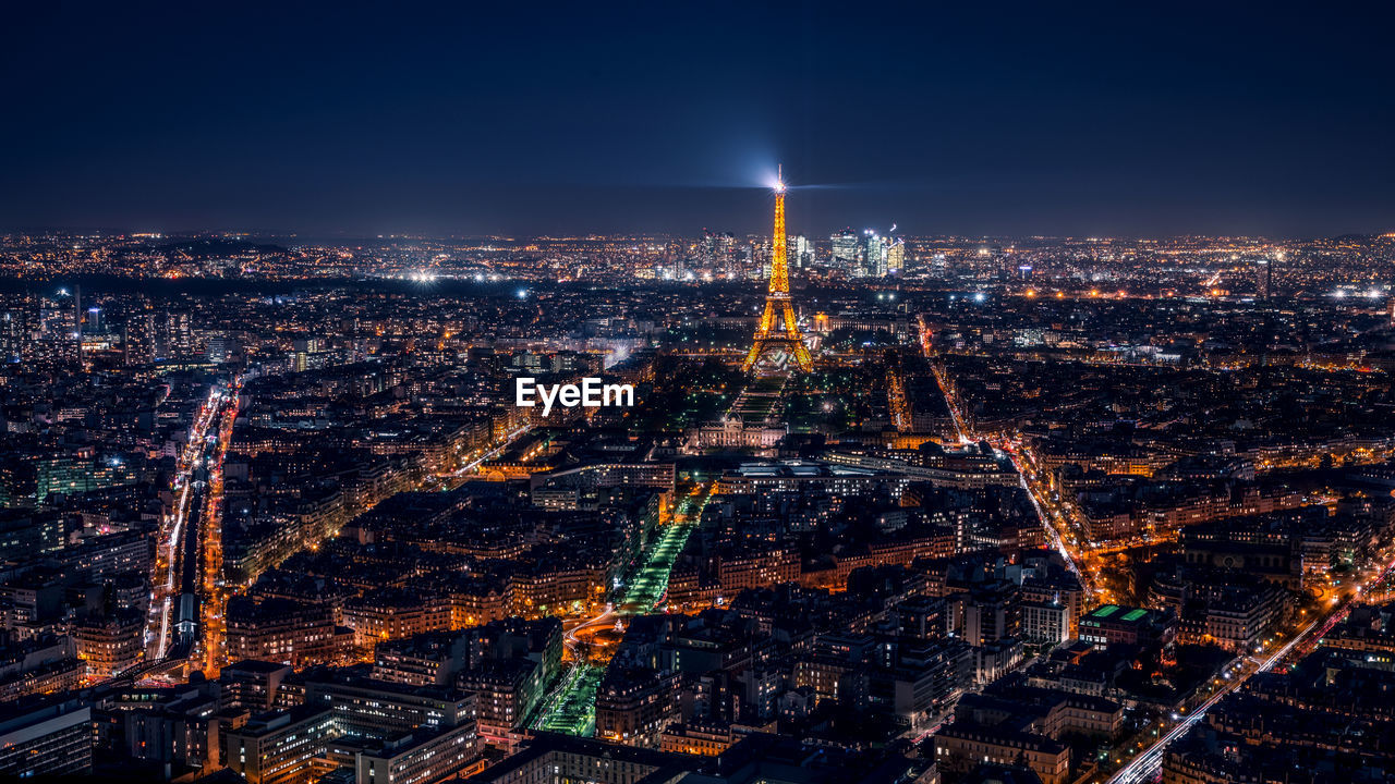 HIGH ANGLE VIEW OF ILLUMINATED CITY BUILDINGS