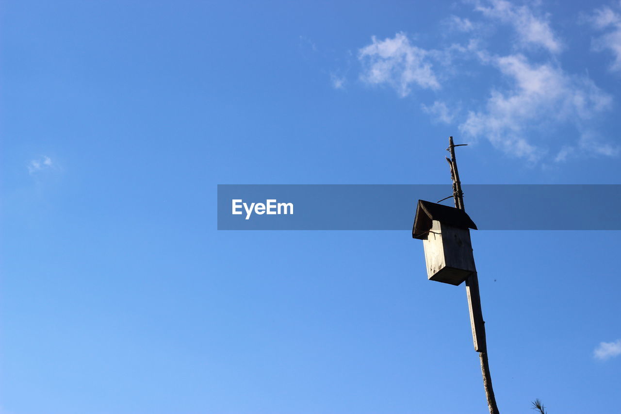 Low angle view of birdhouse against sky