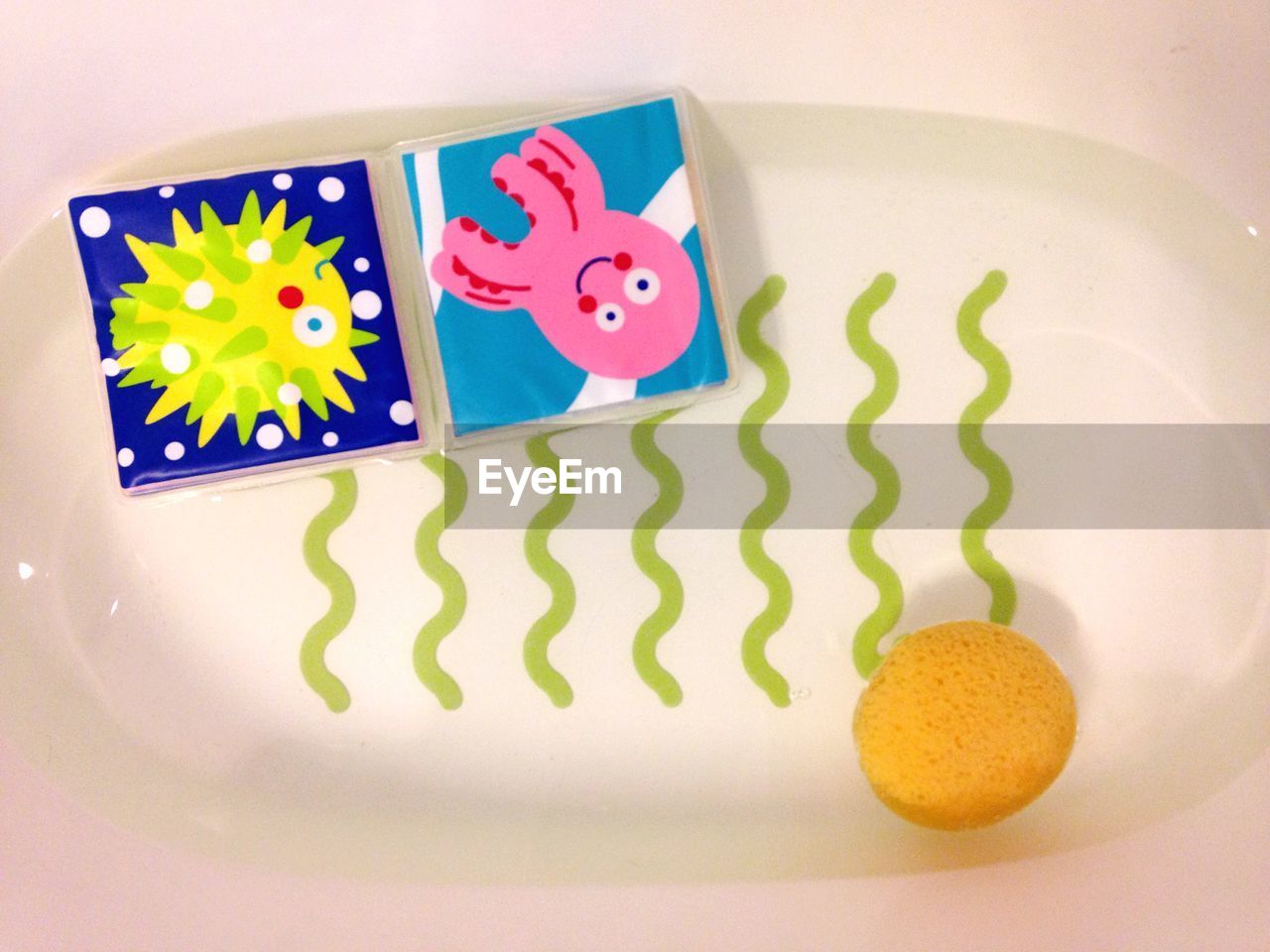 Toys floating in baby bathtub