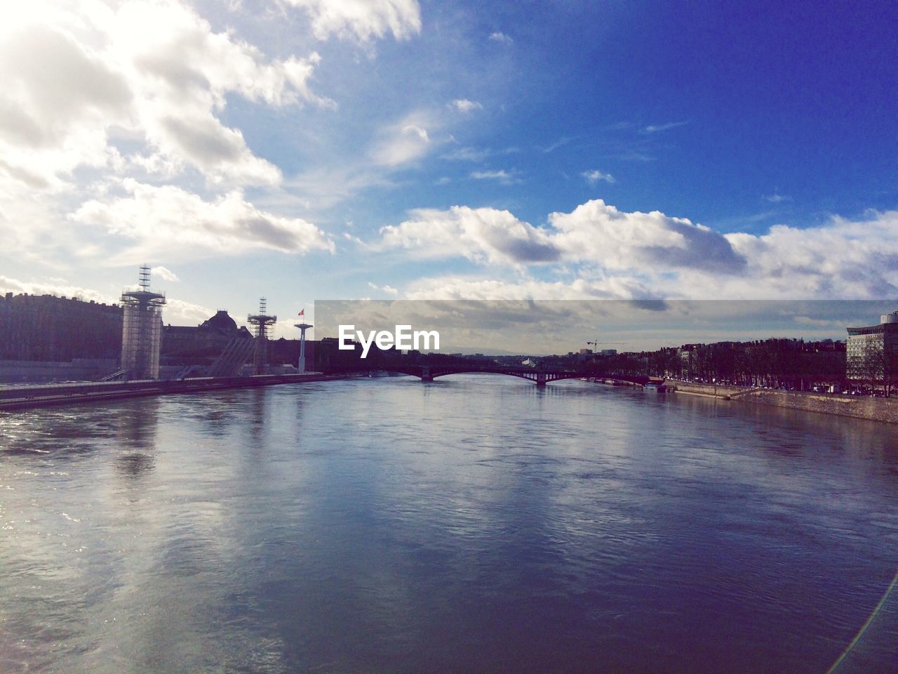 Cloudy sky above river in city