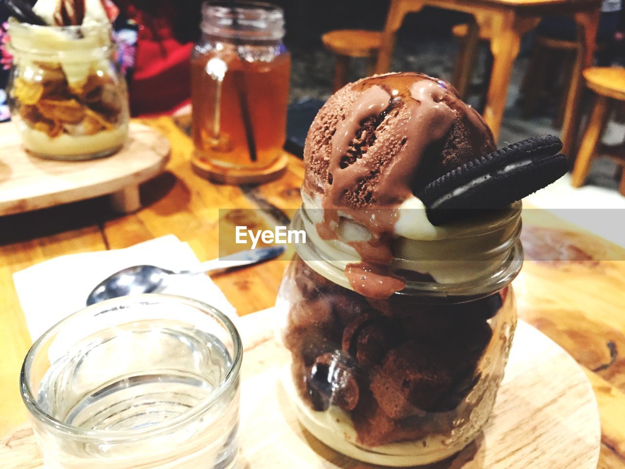 Close-up of chocolate ice cream served with cookie on table