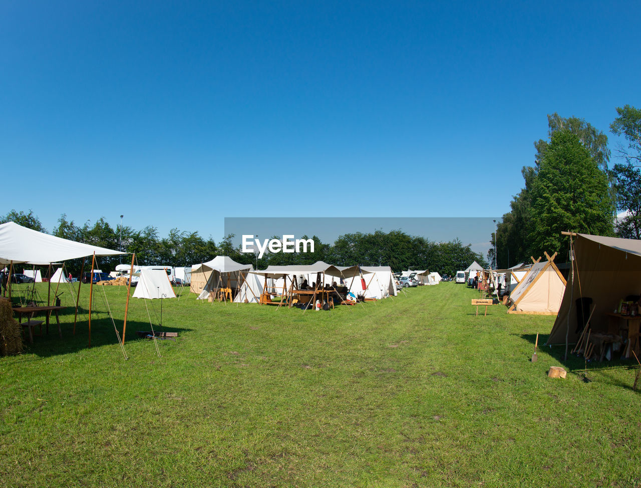 Houses on field against clear sky