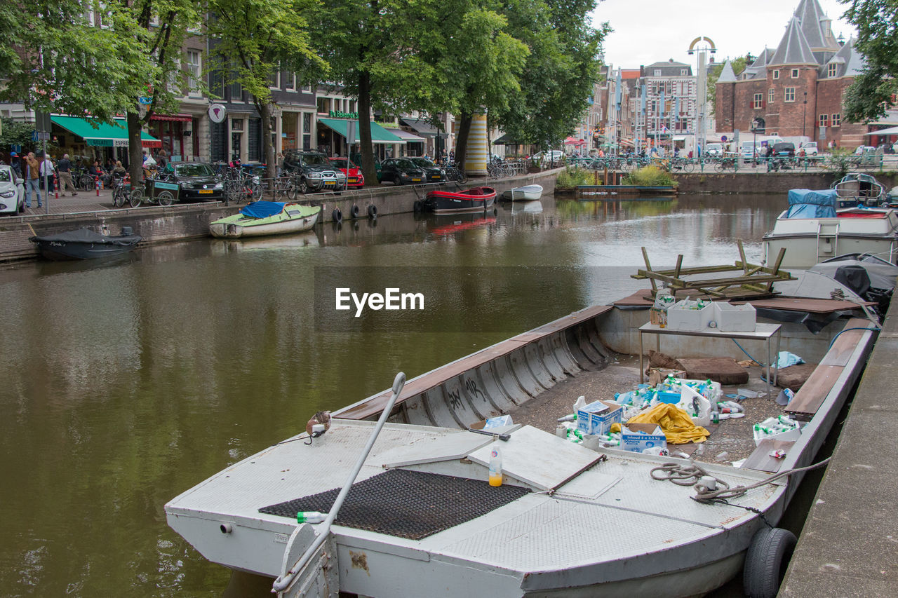 Boats moored in canal against buildings