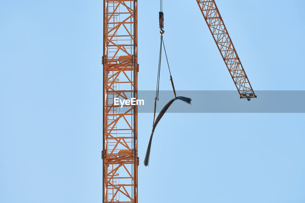 LOW ANGLE VIEW OF CRANE AT CONSTRUCTION SITE AGAINST SKY