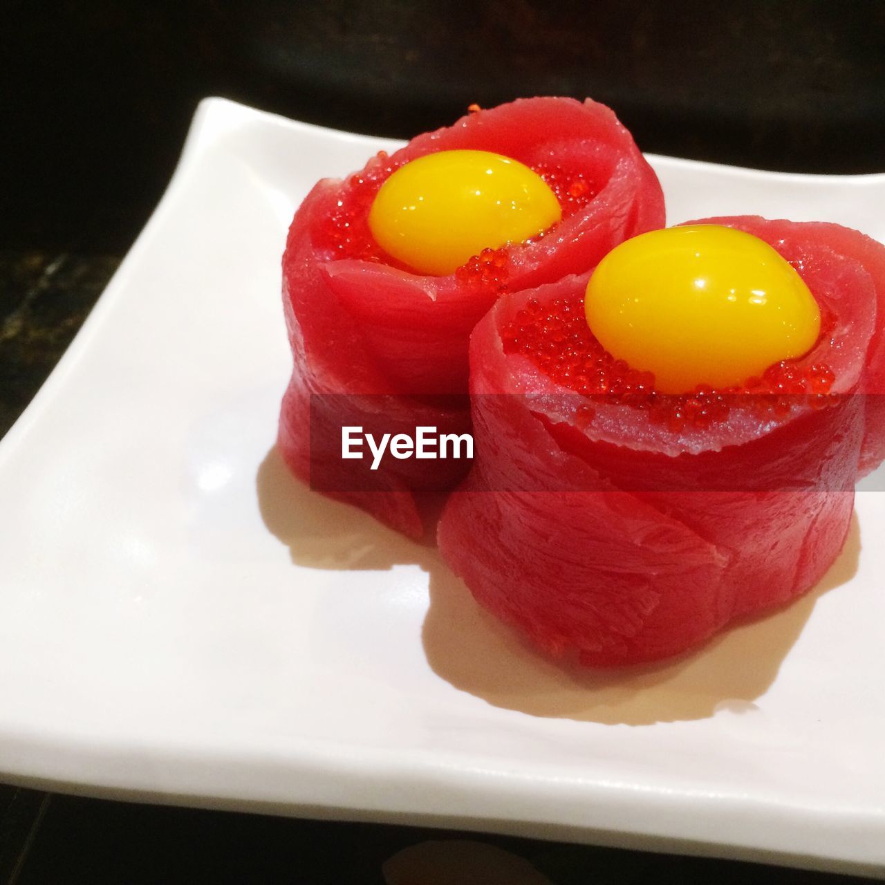High angle view of tuna sushi with eggs served in plate
