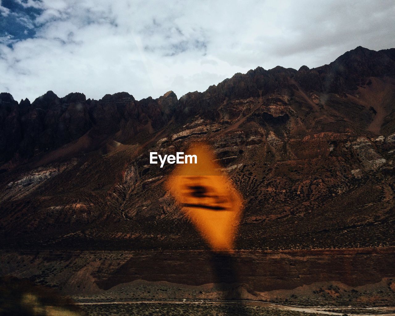 Blurred motion of road sign against mountains