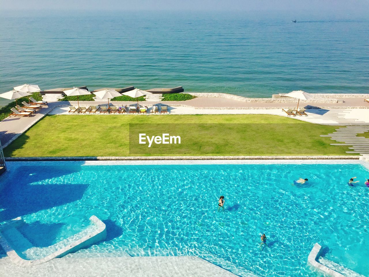 HIGH ANGLE VIEW OF SWIMMING POOL ON BEACH