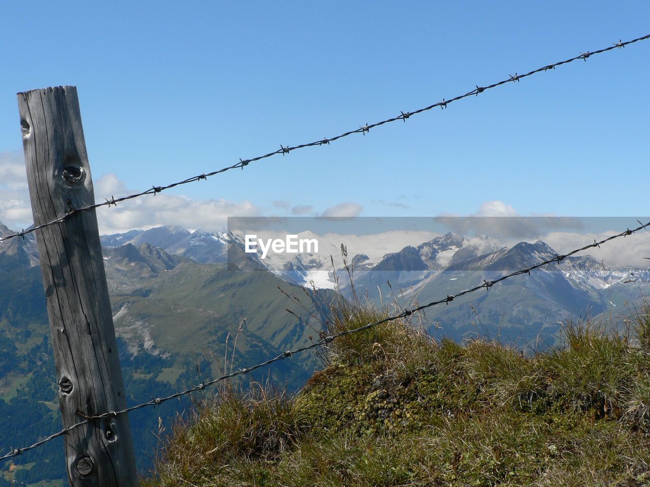 Fence with snowcapped mountain in background