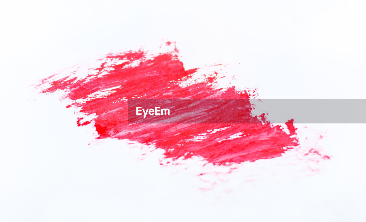 Close-up of red strokes over white background